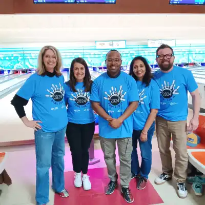 People standing in front of bowling lanes